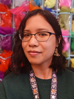 headshot of Angeline Nguyen, an Asian woman wearing glasses